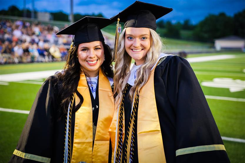 Students graduate on a football field
